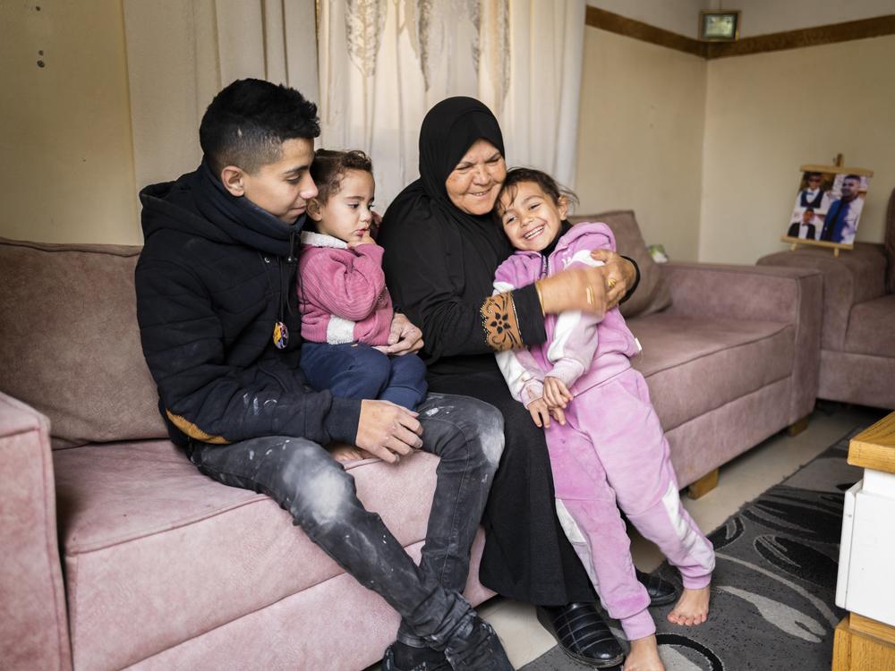 Noor with his two sisters and grandmother in their family home.