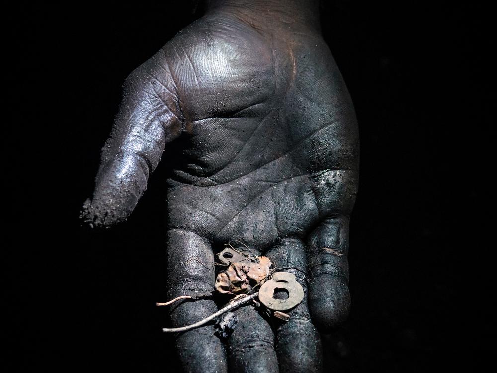 So-called “pickers” sift through the soil at e-waste dumps to find small pieces of precious metals, like these iron and copper fragments that likely came from a burned electrical cable. <br><br>