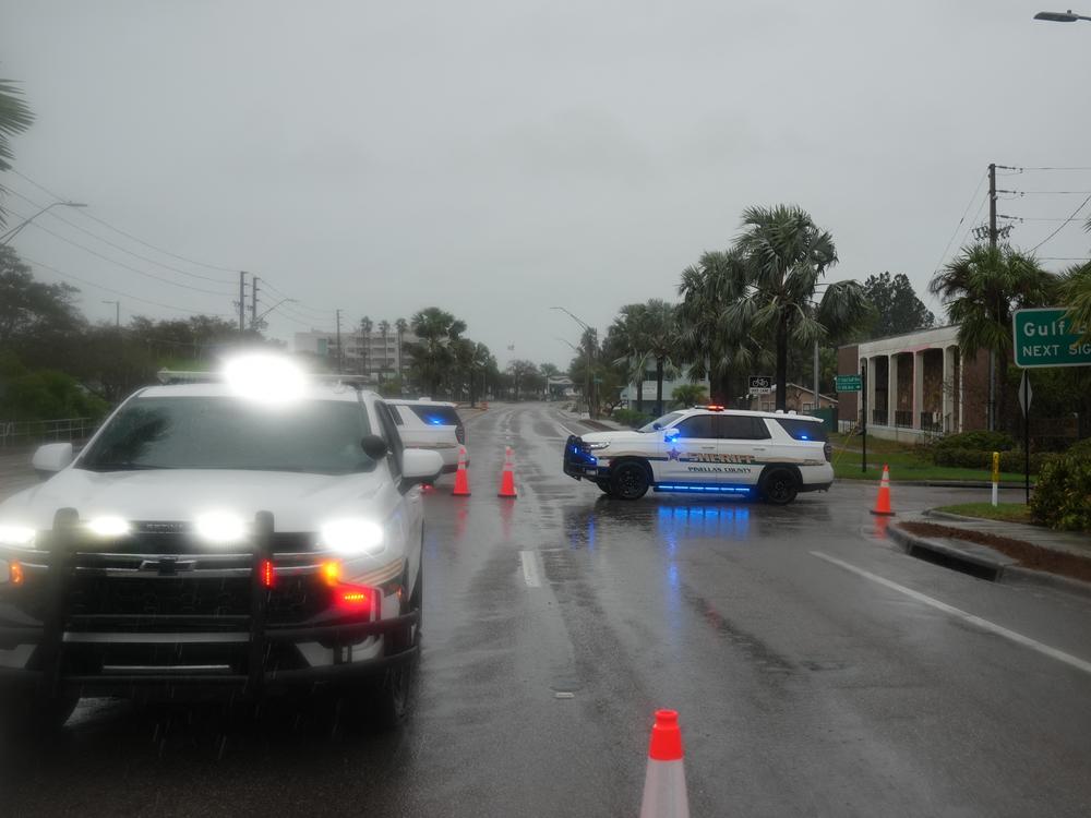 Local police close a crossing from Largo to Indian Rocks Beach on the Gulf of Mexico ahead of Hurricane Milton's expected landfall on Oct. 9, 2024 in Florida.