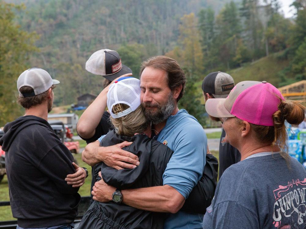 Trey Moore of nearby Erwin, Tenn., hugs community organizer Misty Hughes at the community center in Poplar, N.C.