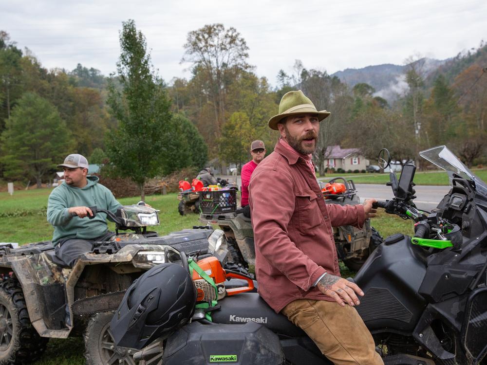 Chris Nash (center) leads a team searching for people who need help after record flooding in Poplar, N.C.
