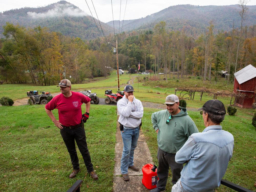 Keith Carrigan (from left) Bryson Griffin and Payton Baucom are volunteers from the Hopewell Baptist church in Fairview, N.C. They've brought fuel for Poplar resident Jarrell Peterson, who's nearly 80 and is using generators after flooding knocked out power.