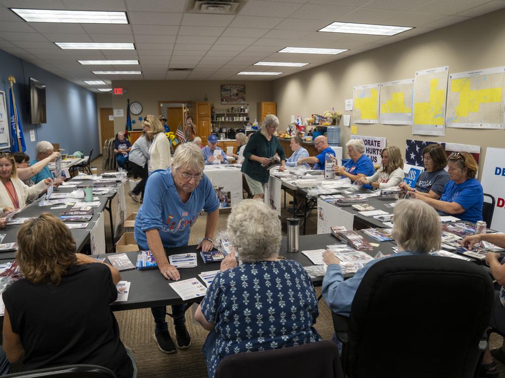 Volunteers for the Walworth County Democrats fold pamphlets for canvassers ahead of this year's presidential election.