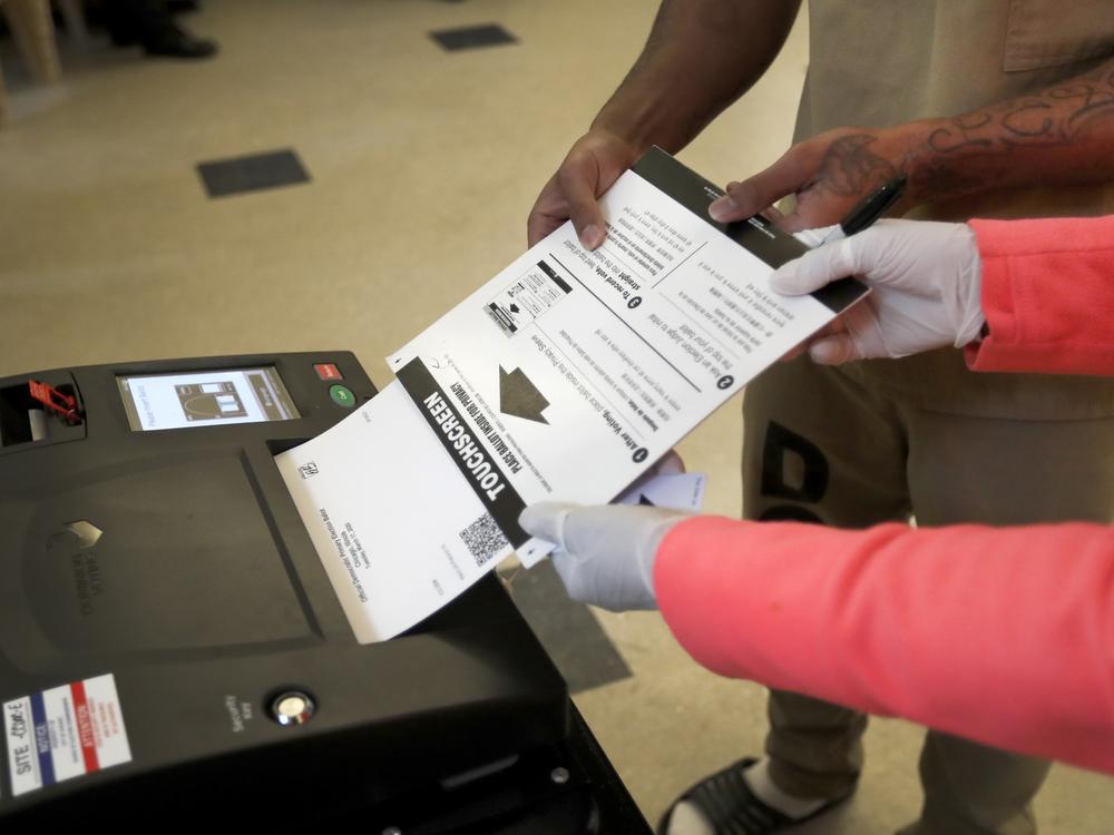A Cook County jail inmate casts his ballot as he participates in early voting during the 2020 Illinois primary at the jail in Chicago.