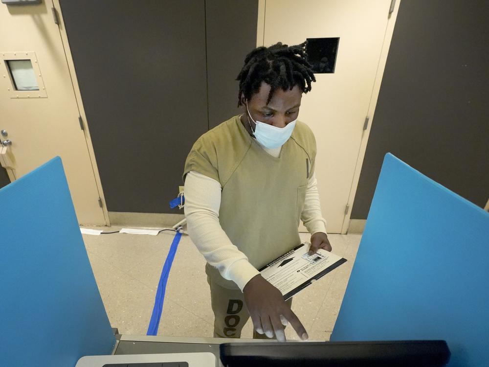 Tykarri Skillon, an inmate at the Cook County, Ill., jail, votes in a local election at the jail's Division 11 Chapel in Chicago.