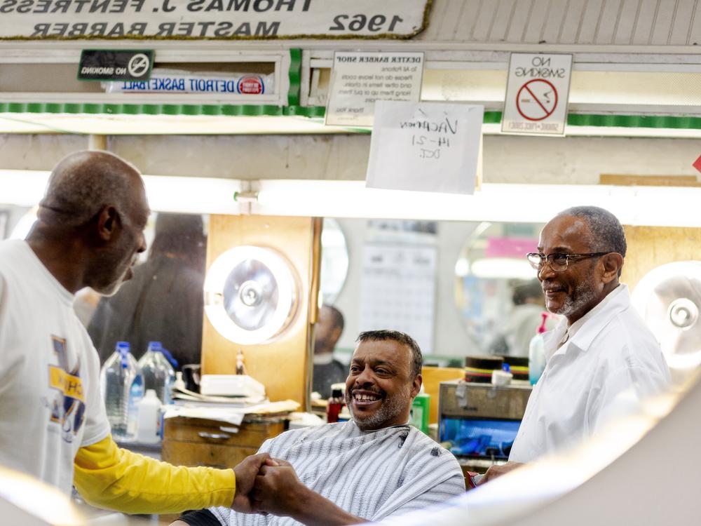 Jerry Montgomery, 65, greets customers while getting his hair cut at Dexter Barber Shop on Oct. 5 in Detroit, Mich. Montgomery plans to vote for Kamala Harris in the upcoming election.