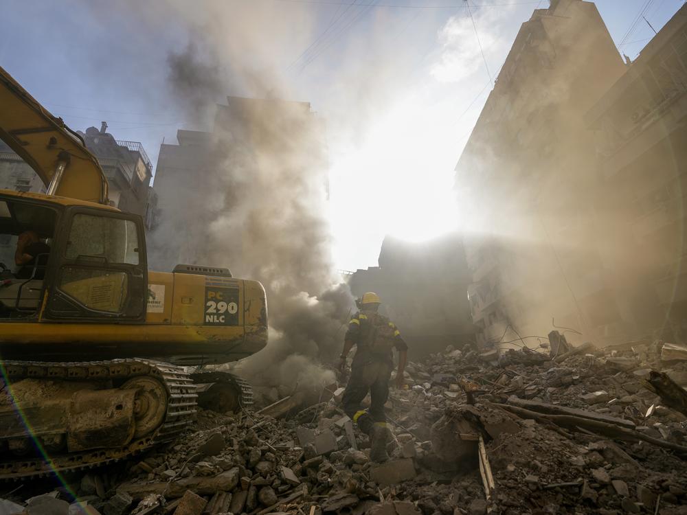 Rescue workers search for victims at the site of Thursday's Israeli airstrike in Beirut on Friday.