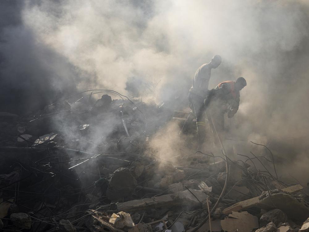 Rescue workers search for victims at the site of Thursday's Israeli airstrike in Beirut, Lebanon, on Friday.