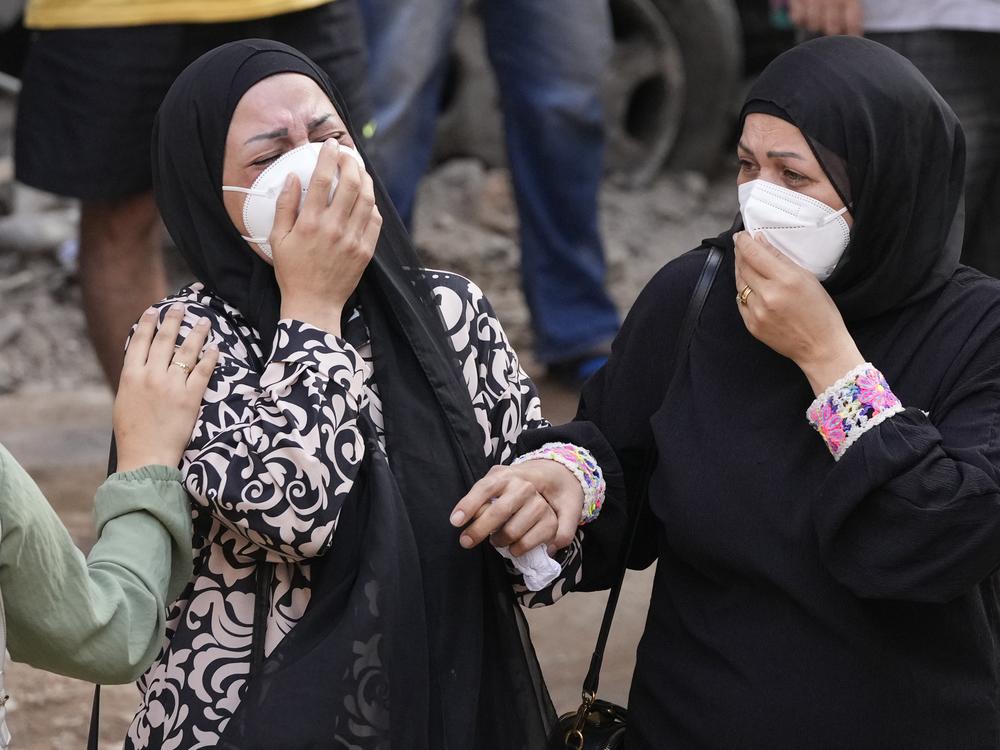 Women react in front of their destroyed apartment at the site of Thursday's Israeli airstrike in Beirut, Friday.