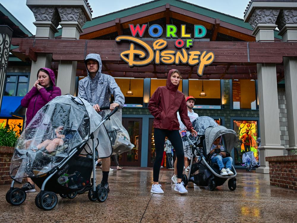 Visitors walk through the Disney Springs shopping center in Orlando ahead of Hurricane Milton's landfall in Florida on Oct. 9, 2024.