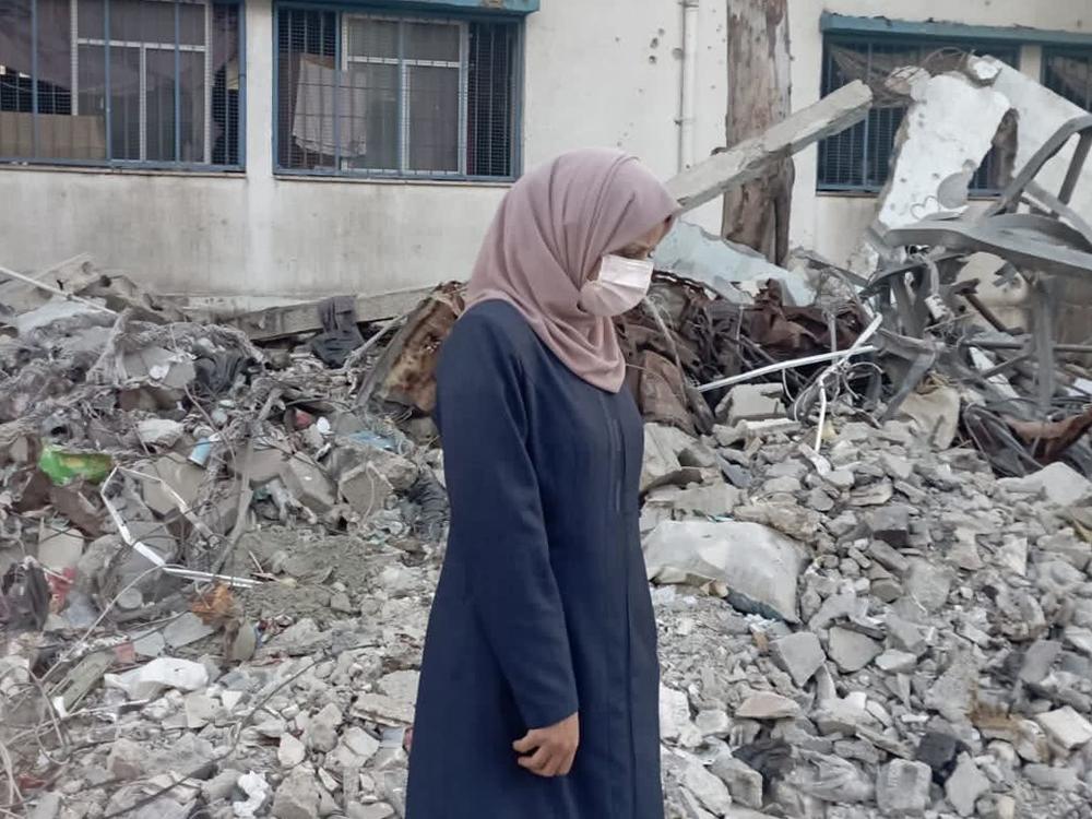 Taqwa Abusaeid stands amid the rubble of a destroyed building in Gaza City nearly a year after surviving the Oct. 31, 2023, Israeli airstrike that killed all her children and other relatives.