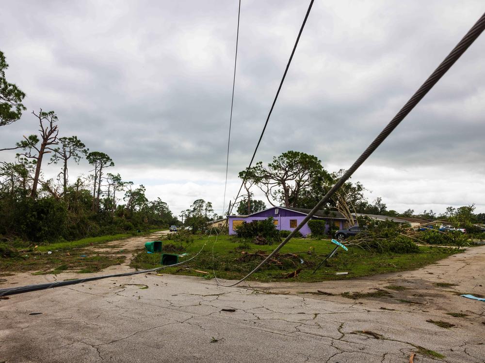 A downed power line and other damage from a tornado caused by Hurricane Milton is seen in Port St Lucie, Fla., on Thursday. The storm triggered some 126 tornado warnings in a short period of time, raising alarms about the impending large hurricane.
