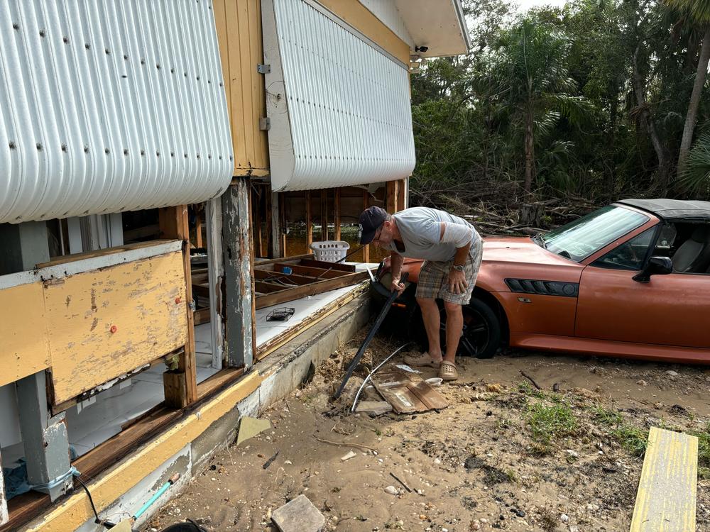 Rick Conflitti surveys the damage at his home in Charlotte Harbor, Fla., on Thursday, hours after Hurricane Milton made landfall nearly 50 miles north.