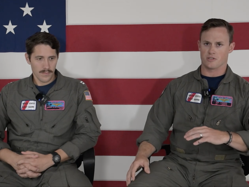 U.S. Coast Guard helicopter pilot Lt. Ian Logan, right, speaks about a rescue mission in which he and another pilot, Lt. Landon Klopfenstein, left, pulled a man from the open water 30 miles off Longboat Key, Fla., on Thursday.