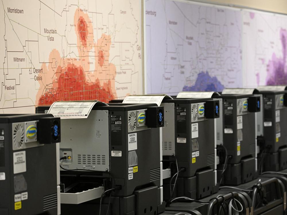 Ballot printers for in-person voting are loaded with test ballots in a storage warehouse at the Maricopa County Tabulation and Election Center in Phoenix on June 3.