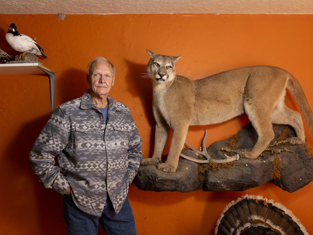 Former Wildlife Services employee Carter Niemeyer displays some of his taxidermy handiwork in his garage in Boise, Idaho.