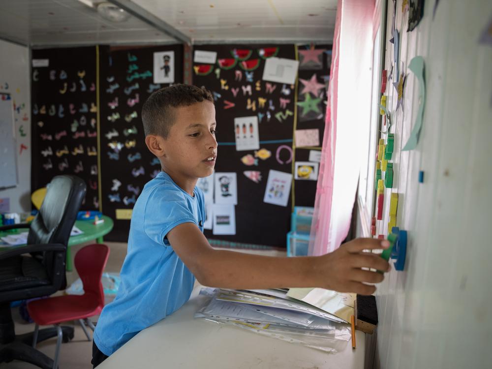 Obeida plays in a classroom at his school after Israeli settlers attacked teachers with bats and tried to break into classrooms where students were sheltering a few days before.