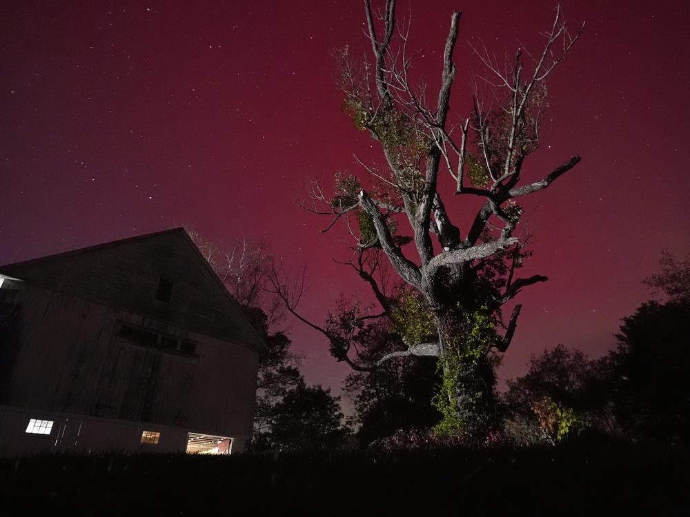 An aurora borealis, also known as the northern lights, glows red in the sky on Oct. 10 in East Derry, N.H.