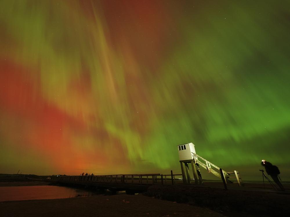 The aurora borealis is seen in an incredible display in the skies above the causeway leading to Holy Island in Northumberland, England, in the early hours or Friday morning.