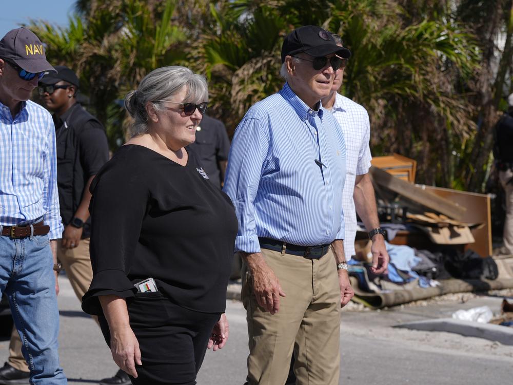 President Biden, right, walks during a tour of areas affected by Hurricane Milton in St. Pete Beach, Fla., following an aerial tour on Sunday.