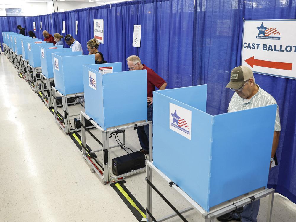 Voters fill out their ballots on the second day of early voting in the 2024 presidential election at the Board of Elections Loop Super Site in Chicago on Oct. 4.