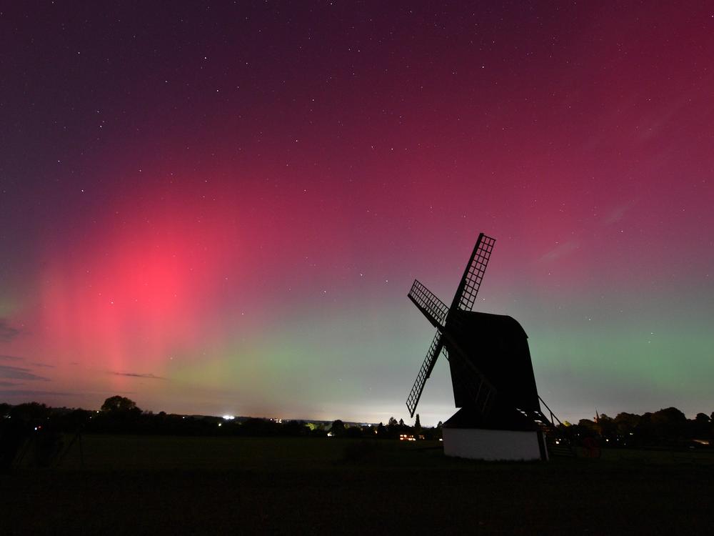 The aurora borealis lights up the night sky over Pitstone Windmill in Buckinghamshire on Oct.10, in Pitstone, UK.