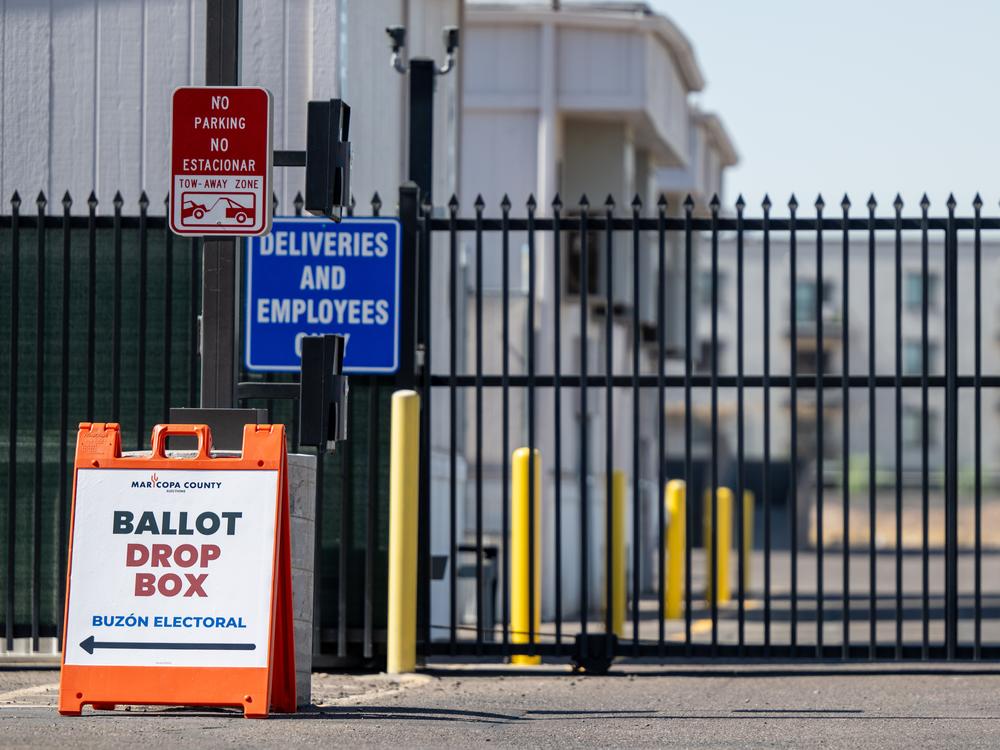 Ballot drop-off instructions are displayed near the entrance of the Maricopa County Elections Department on Oct. 11 in Phoenix. Early voting is underway in Arizona ahead of the Nov. 5 elections.