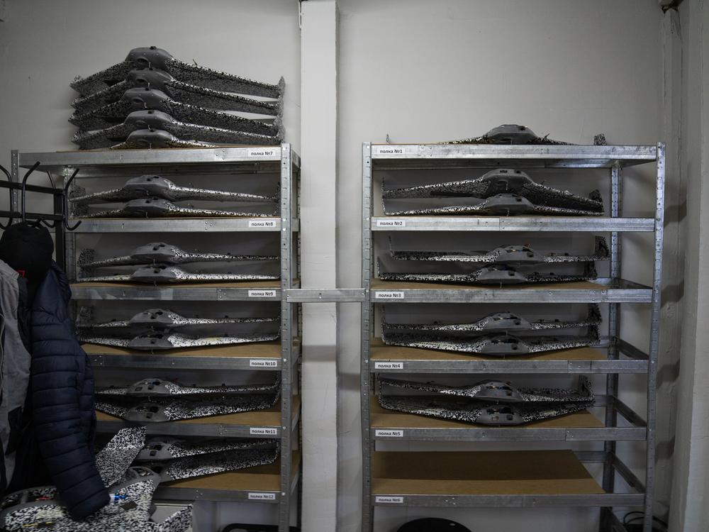 Completed drone bodies rest on shelves in the back of the workroom at Skyassist in Ukraine.
