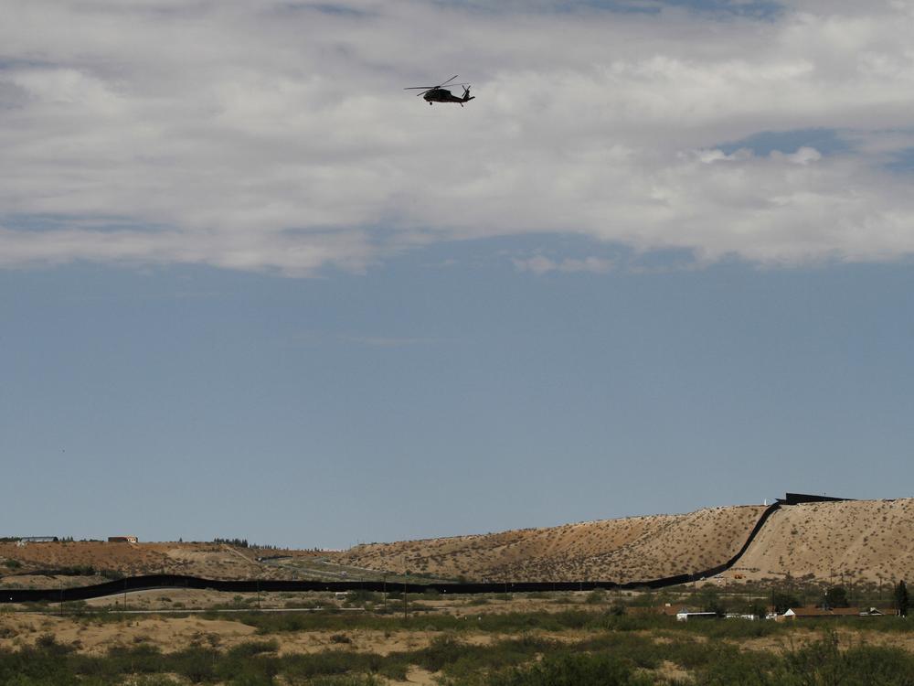 A surveillance helicopter traces a line in the sky above the Southwest border with Mexico at Sunland Park, N.M., Thursday, Aug. 22, 2024.