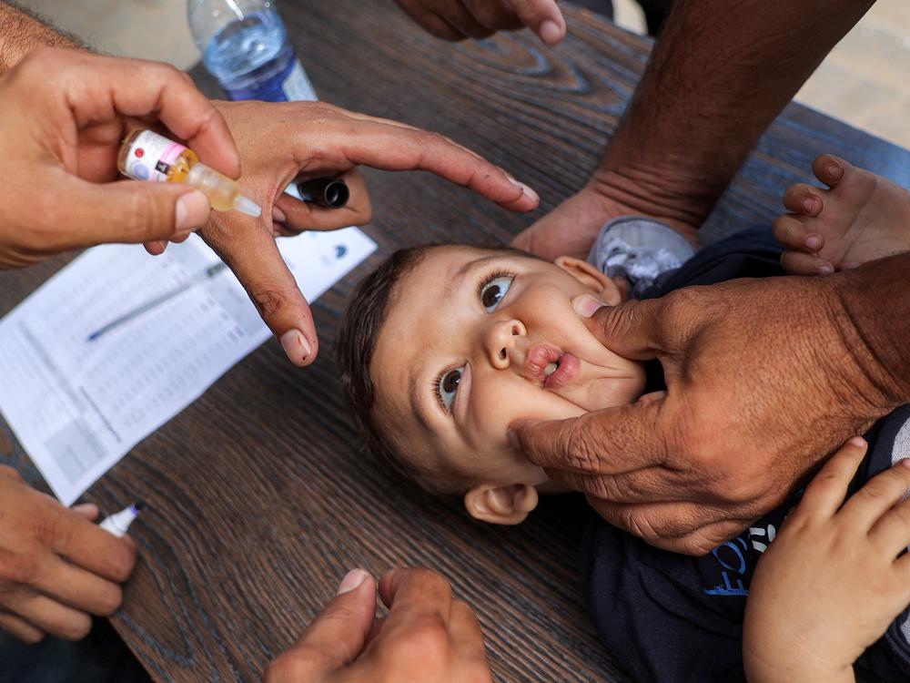 A young child is restrained before receiving a vaccination for polio in Deir el-Balah in the central Gaza Strip on Sept. 4 during the first round of a massive polio vaccination campaign led by the United Nations.