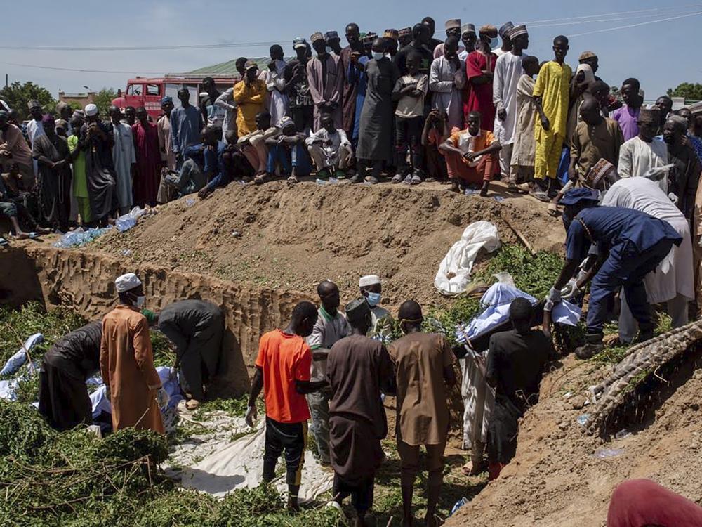 People prepare bodies for funeral following a tanker explosion in Majiya town, Nigeria, on Wednesday.