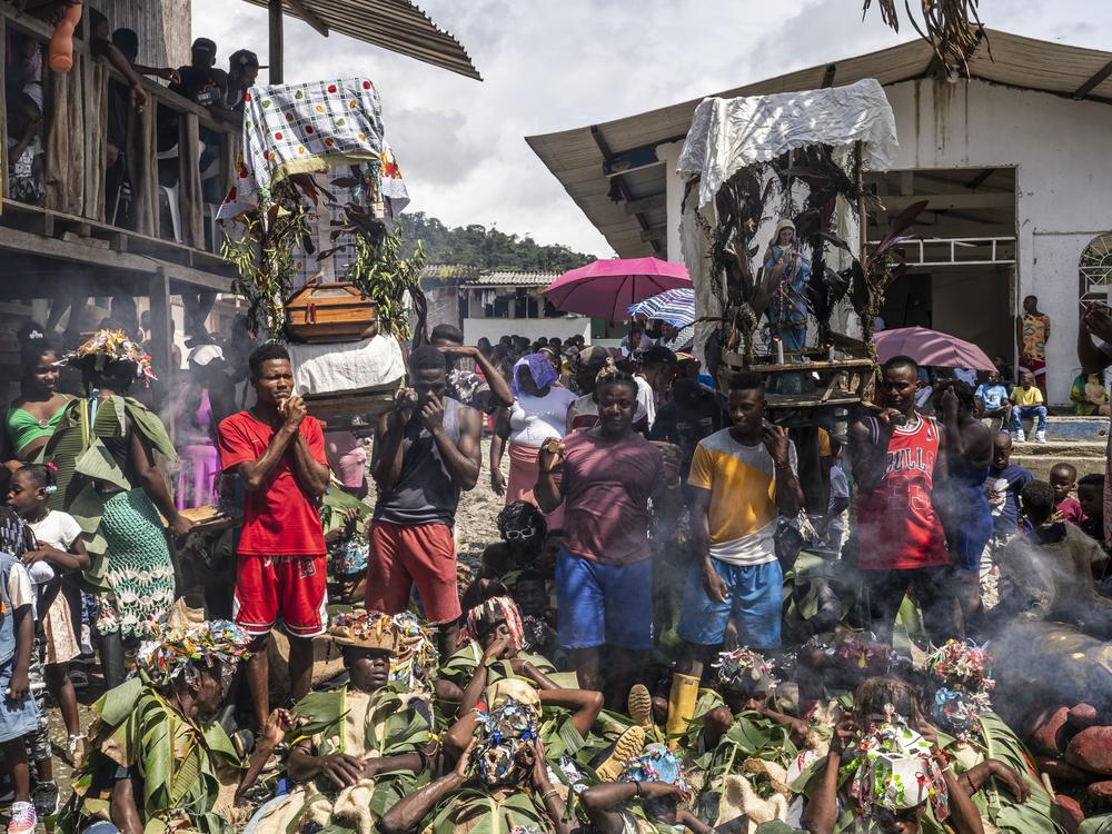 People carry religious representations while walking on the Manacillos on March 31, 2024, in the town of Juntas, Buenaventura, Colombia.
