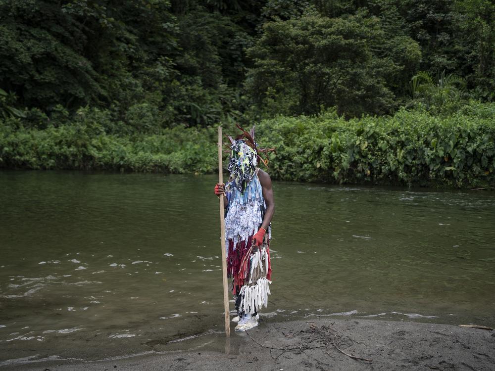 A person wears a Manacillo costume representing the Pharisee soldiers who collaborated with the death of Jesus Christ, on March 31, 2024, in the town of Juntas, Buenaventura, Colombia.