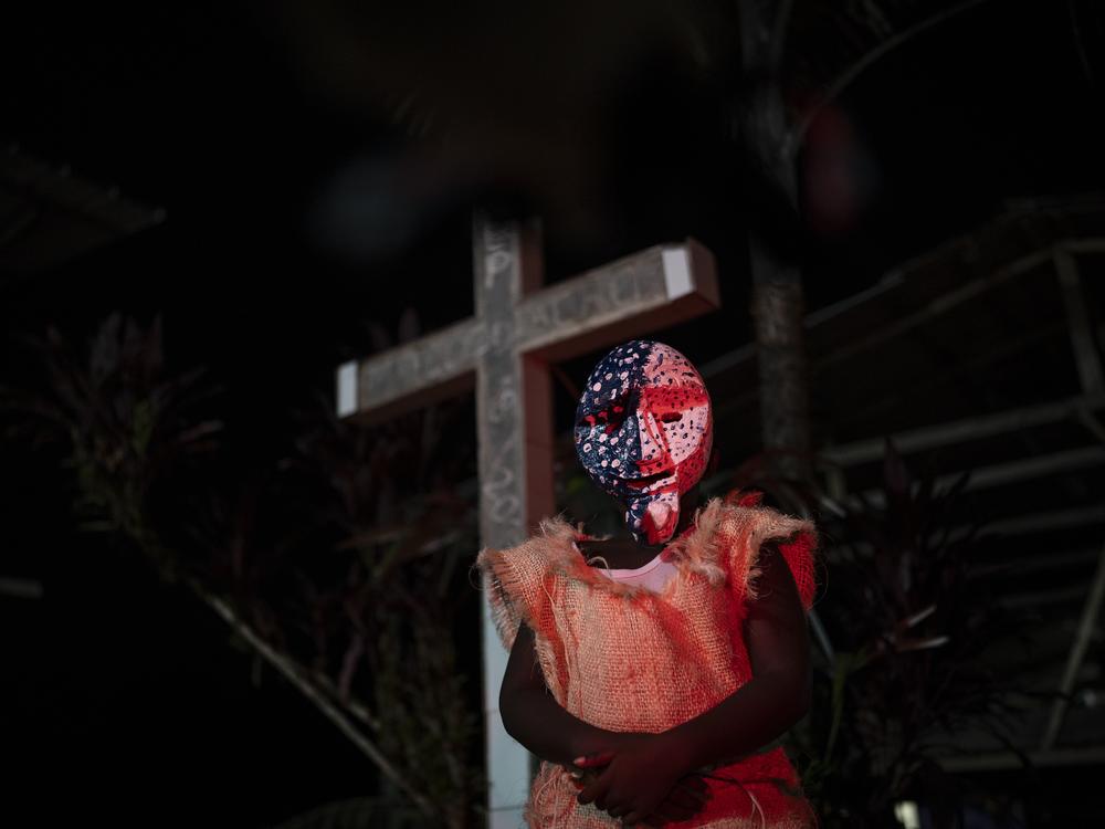 A child dresses up as a Manacillo on March 30, 2024, in the town of Juntas, Buenaventura, Colombia.