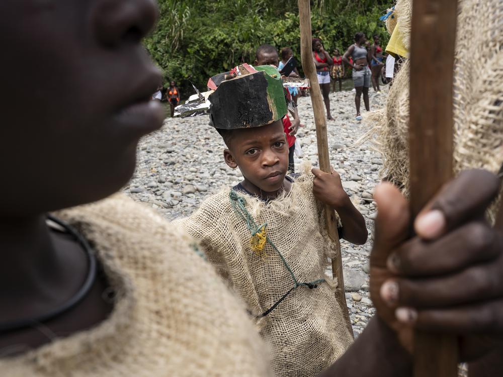 Children disguised as Manacillos in the Yurumangui River on March 31, 2024, in Juntas, Buenaventura, Colombia.