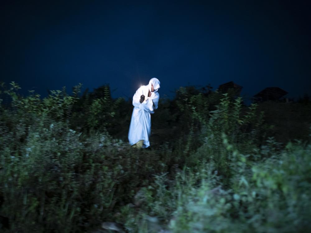 People dress up as souls in purgatory coming down from the cemetery at midnight on March 29, 2024, in the town of Juntas, Buenaventura, Colombia.