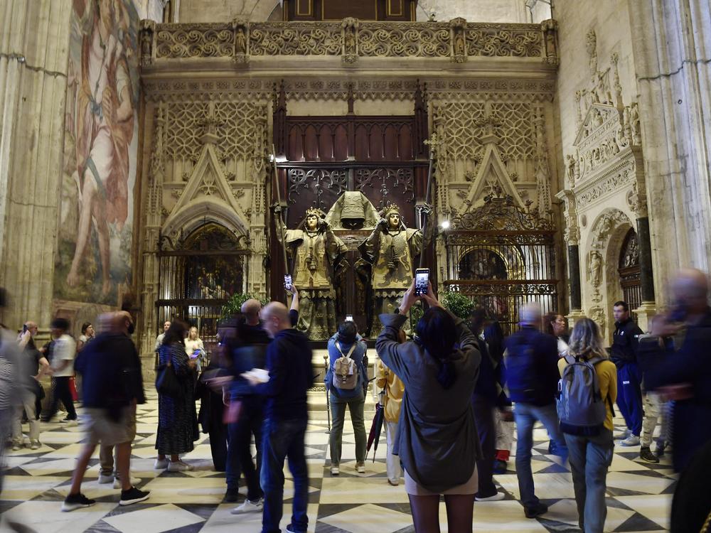 People visit the tomb of Christopher Columbus at the Cathedral of Seville on October 11.
