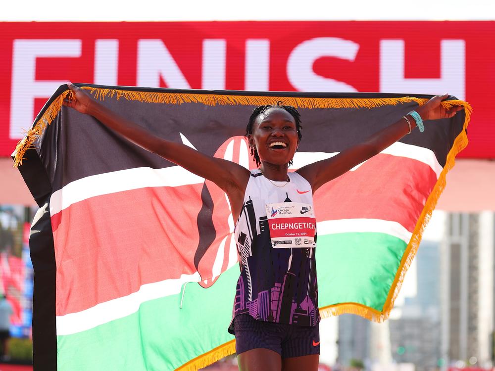 Ruth Chepngetich of Kenya celebrates after crossing the finish line to win the 2024 Chicago Marathon with a new world record time of 2:09:56 at Grant Park in Chicago on Sunday.