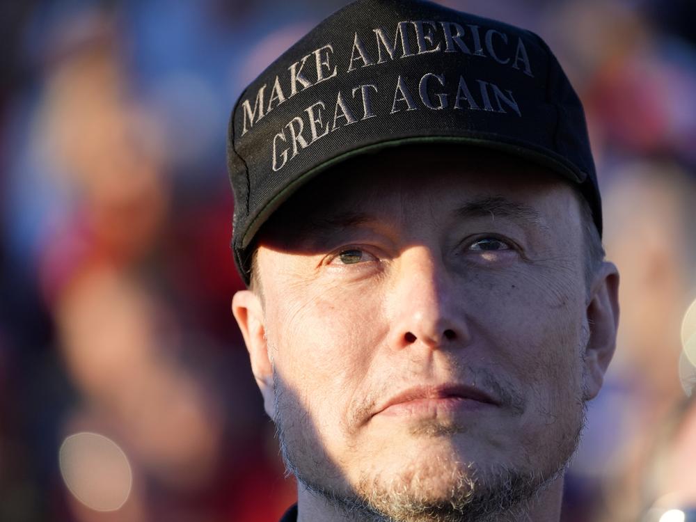 Tesla and SpaceX CEO Elon Musk listens as Republican presidential nominee former President Donald Trump speaks at a campaign event in Butler, Pa., on Oct. 5.