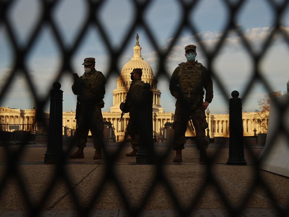 WASHINGTON, DC - JANUARY 14: Members of the New York National Guard stand guard along the fence that surrounds the U.S. Capitol the day after the House of Representatives voted to impeach President Donald Trump for the second time January 14, 2021 in Washington, DC. Thousands of National Guard troops have been activated to protect the nation's capital against threats surrounding President-elect Joe Biden’s inauguration and to prevent a repeat of last week’s deadly insurrection at the U.S. Capitol. (Photo b…