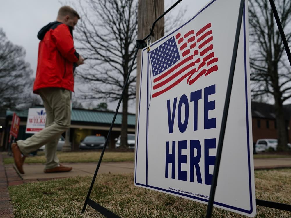 A voter walks toward a polling place to cast their ballot for Alabama’s March primary election in Mountain Brook, Ala.