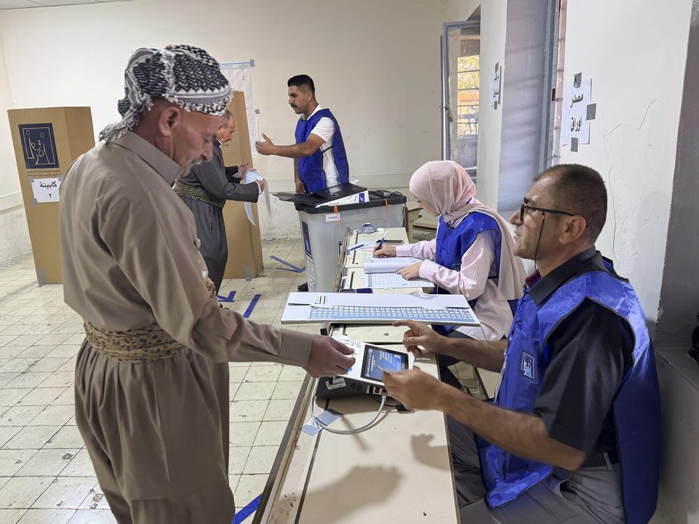 A man registers to vote during parliamentary elections of Iraq’s semi-autonomous northern Kurdish region in Irbil on Sunday.
