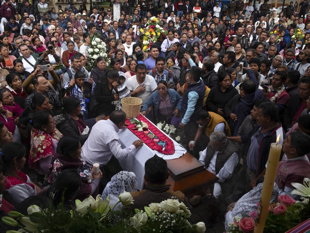 People gather around the coffin of slain Catholic priest and activist Marcelo Pérez during a mass at the main plaza in San Andrés Larráinzar, Chiapas state, Mexico, on Monday.