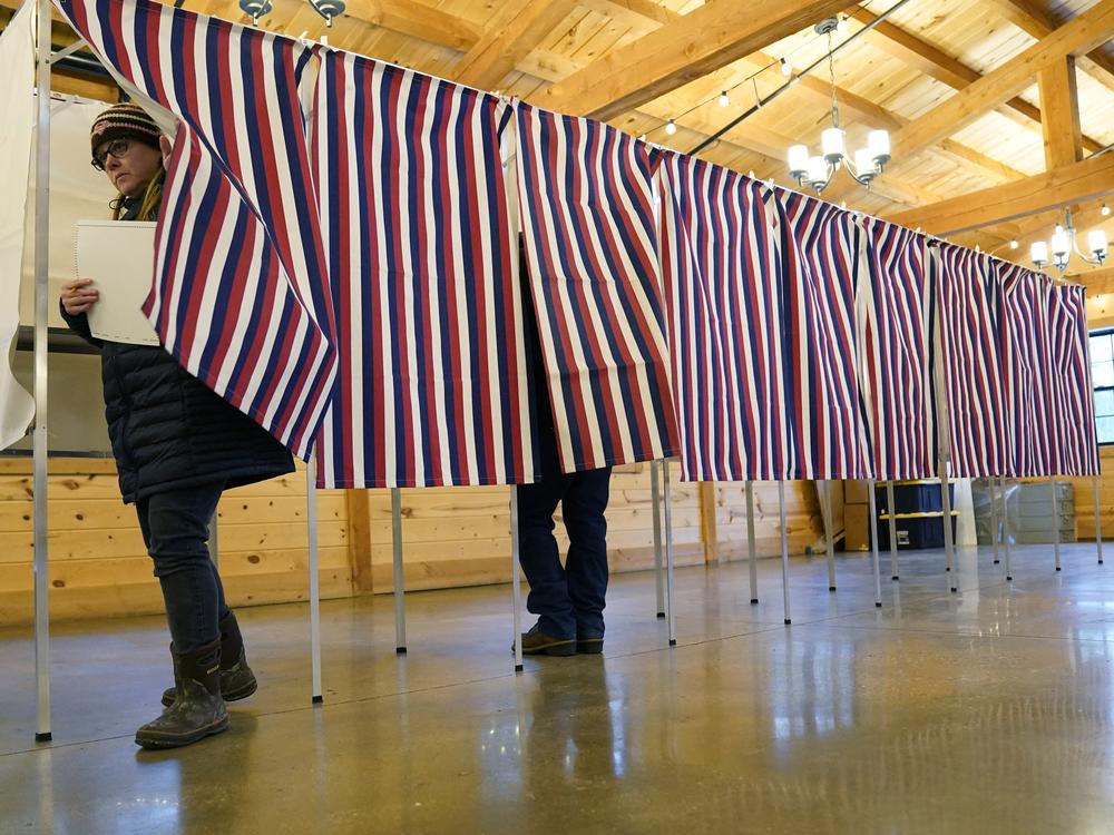 Voter leave a voting booth at The Barn at Bull Meadow in Concord, New Hampshire, during voting for the New Hampshire Primary on January 23, 2024.