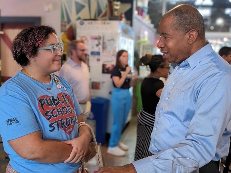 Democratic nominee for North Carolina Superintendent of Public Instruction Mo Green speaks with voter Erin Lynch at a campaign event in Wilson, North Carolina.