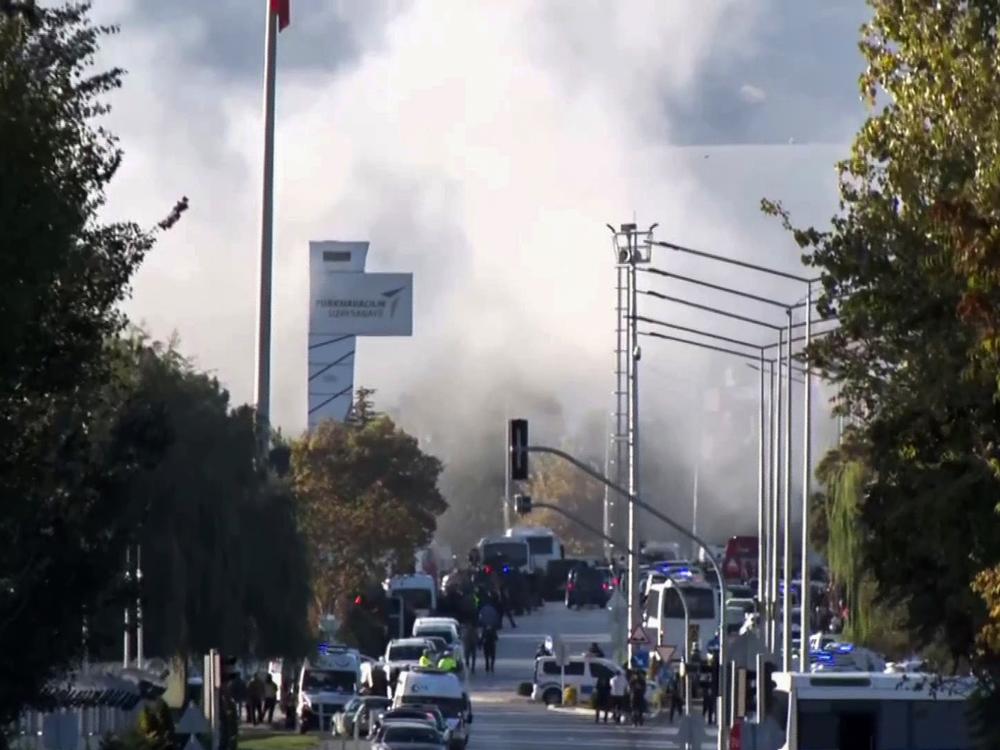 Smoke rises as emergency rescue teams and police officers attend to the scene of an attack outside Turkish Aerospace Industries Inc. on the outskirts of Ankara, Turkey, Wednesday.