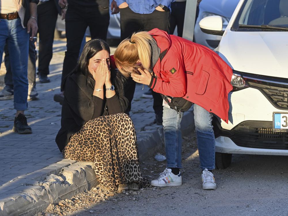 People gather outside of Turkish Aerospace Industries Inc. on the outskirts of Ankara, Turkey, after an attack Wednesday.