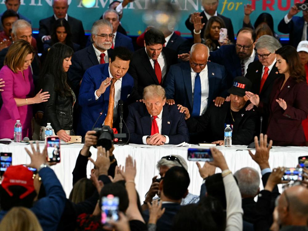 Former President Donald Trump prays during a roundtable discussion with Latino community leaders at Trump National Doral Miami in Florida on Tuesday.