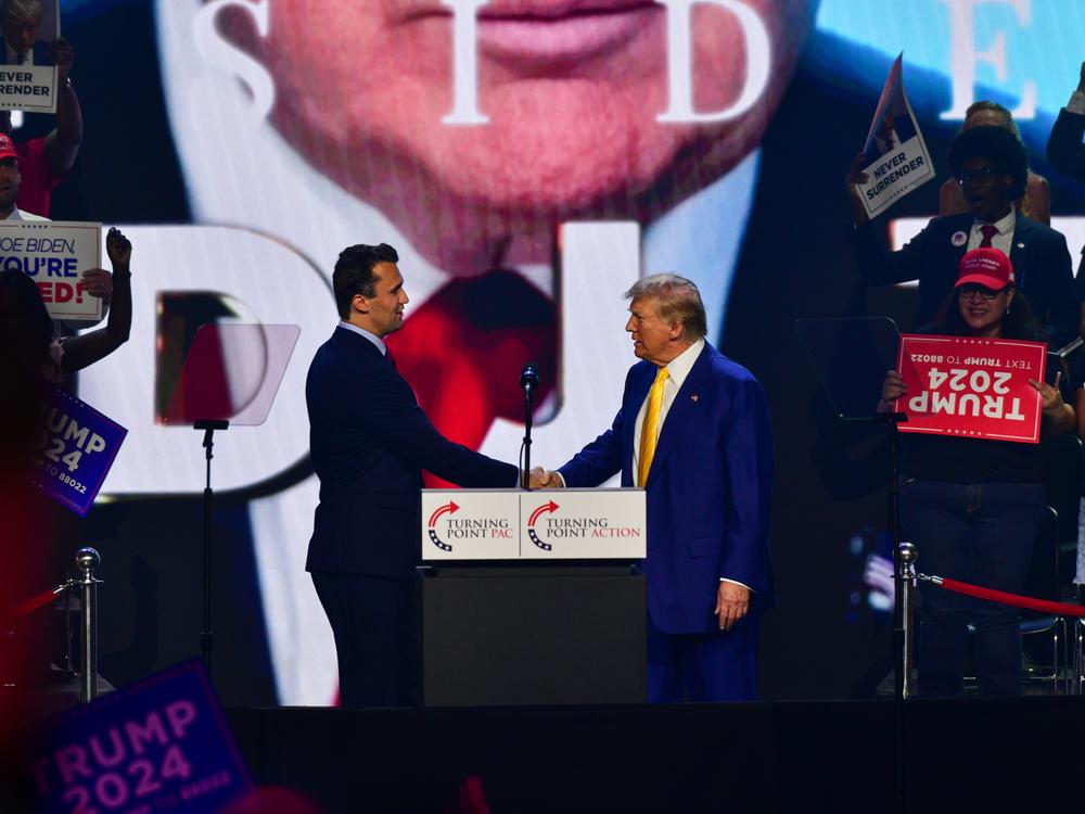 Former President Donald Trump is greeted by Charlie Kirk at an event organized by Turning Point Action at Dream City Church in Phoenix on June 6.