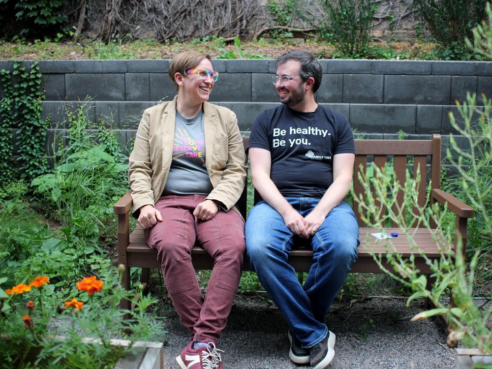 Dr. Kelsey Leonardsmith (left) with colleague Dylan Flunker in the garden of Family Tree Clinic in Minneapolis. The two run a program to train more doctors and nurses in the region to be able to provide gender affirming care, which is legal in Minnesota, but banned for youth in dozens of states around the country.